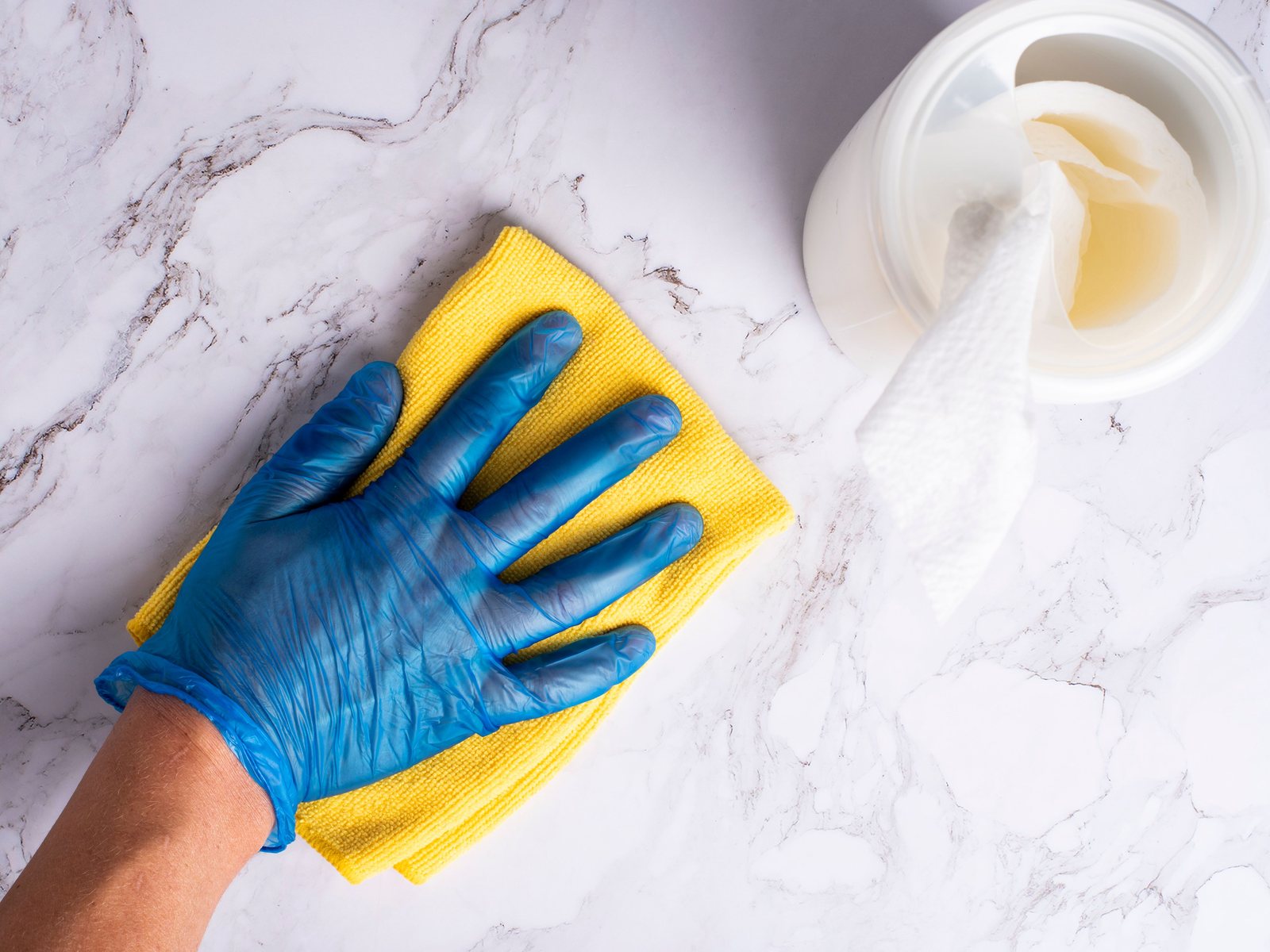 Gloved hand wiping a countertop